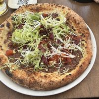 One of the 4 vegan pizza. This one is the Veganella. Base is puréed olives. Very oily. Couldn’t finish it.  at Luigia in Fribourg