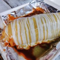 Vegan mojado burrito half red half green sauch at Gordos Mexican Food in Waialua