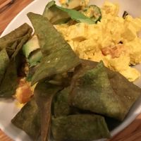AGV Scramble with tofu, peppers, onions, tomato, avocado, almond milk, fried kale leaves and crispy spinach chips. at Cafe Nola in Frederick