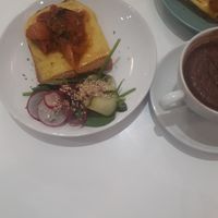 Brunch toast with cheese and roasted tomato, was too salty, specially the salad at Maria Limão in Porto