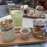 Granola, fresh fruit and vegan vanilla yoghurt; ginger and mint lemonade at Maria Limão in Porto