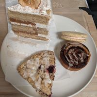 my chosen treats today (January 2021) - cake, sandwich cookie, cinnamon roll, jam scone at Flourchild Vegan Baking  in Courtenay