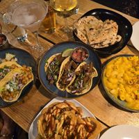Clockwise L-R: chickpea tacos, spicy seitan tacos, garlic bread,  mac'n'cheez, "ring of fire" spicy onion rings (bottom of picture) at Plant Base in Lisbon