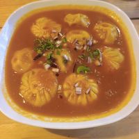 Momo in tomato curry sauce at Plant Base in Lisbon
