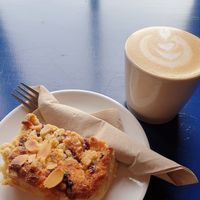 Raspberry bakewell + oat cappuccino at Yallah Coffee Kiosk in St Ives