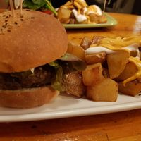 Black burger and bravas at Cat Bar in Barcelona