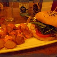 Vegan Burger with fried potatoes and spicy sauce at Cat Bar in Barcelona