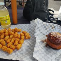Now that's what I call a birthday lunch - Nashville Hot Chicken sandwich and tater tots. at Nom Burgers in Austin