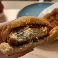 Nashville Hot Chicken sandwich and tater tots - take a bite, I know you want to! at Nom Burgers in Austin