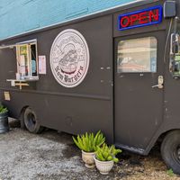 Parked where Vegan Nom used to sit, Vegan Nom is now across the yard at Nom Burgers in Austin