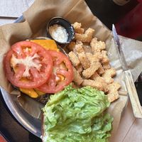 Lettuce, tomatoes, avocado, vegan cheese topping a black bean burger with vegan mayo on the side   at Stack'd Bar in Milwaukee