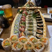 Sushi boat with our table’s sushi (including non-vegan rolls). We got the avo/cucumber roll, eddie vedder roll, and ebicado roll.  at Yagi Sushi and Hibachi in Pawleys Island