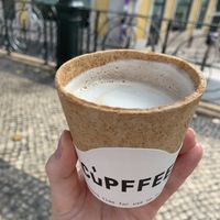 Yummy soy latte with cracker type cup (pigeons love it)  at Vegan Nata - Chiado in Lisbon