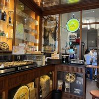 Tarts keeping warm and stools on right    at Vegan Nata - Chiado in Lisbon