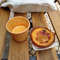 Espresso in biodegradable cup and vegan pastry at Vegan Nata - Chiado in Lisbon