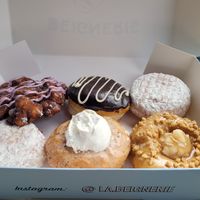 Blueberry fritter, Crème St-Denis, 2×jam la confiture (jelly powdered donuts), Crème brûlée?, Á en tomber dans les pommes (apple caramel with nuts) at La Beignerie in Montreal