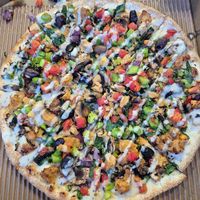 Vegans paradise pizza 22.95: quite small, base was thin and cardboardy, toppings were great and diced which i love, loved the crumbled chikn, drizzled with thin tahini dressing at OOSHMAN in Randwick