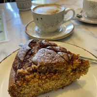 Orange cake and coffee with oat milk at Bloomy Market in Setubal