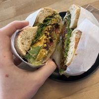 2000 and Juan - a burrito bagel with a bean/quinoa patty, guacamole, tomatoes, crushed corn chips, chipotle mayo (vegan), and lettuce on a rosemary bagel. Filling! Delicious!  at Beam Me Up Bagels - City in Dunedin