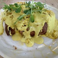Eggs Benedict with sourdough bread   at Pequeno Café e Bistrô - Arroios in Lisbon