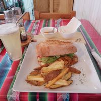 Sándwich Vital:  tofu apanado, cebolla caramelizada, mix de hojas verdes , queso vegano, tomate, babaganush con papas rusticas at Estrella Negra in San Pedro De Atacama