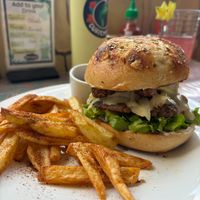 Seitan, coconut tempeh bacun and avo burger with Cajun fries. at Salud Para Vida in San Pedro La Laguna