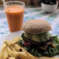 The special, spicy pineapple tempeh avocado with a carrot sunrise cold pressed juice at Salud Para Vida in San Pedro La Laguna