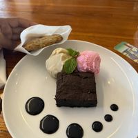Brownie, vanilla & strawberry ice cream with chocolate sauce and oatmeal cookie.  at Level Up Board Game Cafe in Seminyak