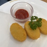 Croquettes with ketchup on the side   at KOMEDA is in Tokyo
