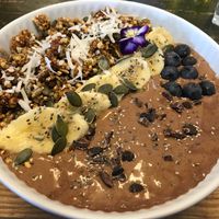 Cocoa, coconut, date smoothie bowl with granola & fruit at Wise Cicada Wholefood Cafe in Auckland
