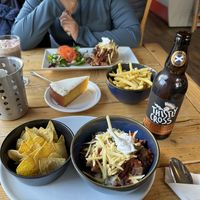 All vegan: baked potato with chili, rice with chili, tortilla chips, lemon icing cake, hot chocolate with marshmallows, fries and a Scottish cider.   at Ness Deli in Drumnadrochit