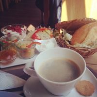 vegan breakfast platter: 5 different breads, two spreads, margarine, marmalade, soy yogurt with pomegranate, apples and some sort of citrus, chopped veggies and vegan sliced bratwurst at Köhlers - Karmelitenstr in Wurzburg