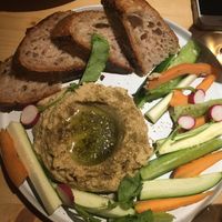 Hummus plate with veggie sticks and sourdough bread at Flores Da Pampa in Lisbon