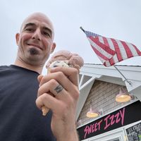 Strawberry and Cookies & Cream in a cone.  at Sweet Izzy in Harwich Port
