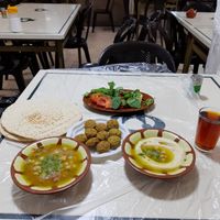 The perfect feast - falafel, fuul, hummus, pita, chai, and the garnish at Hashem in Amman