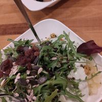 Stuffed potato filled with chickpeas, rucola, raisins, bulgur and a super nice vegan aioli. at Kartoffelspeicher in Luebeck