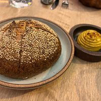 Sesame-leek bread with marigold “butter”  at Oyster Oyster in Washington