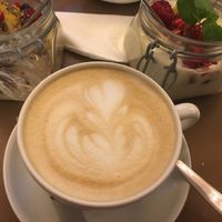 Großer Cappuccino und Sojajoghurt mit Obst und Porridge at Tomasa in Berlin
