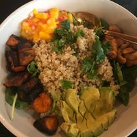 Tropical Veggie Bowl: Charred sweet potato, quinoa, mango, avocado, candied cashews. at Moniker Bar in Richland