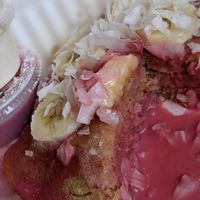 Breakfast pancakes with housemade pink coconut syrup, bananas and coconut at Bloom in Logan