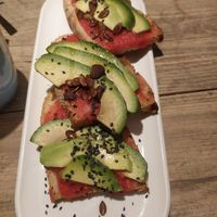 Avocado toast with tomato at UNO Caffé Olistico in Bologna