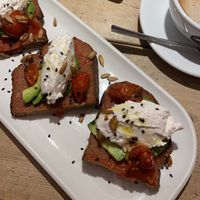 tostada with ricotta, avocado and baked tomato  at UNO Caffé Olistico in Bologna