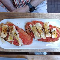 Toast with tomato and goat cheese at UNO Caffé Olistico in Bologna