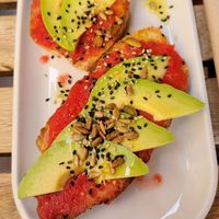 Tostada with fresh tomato and avocado at UNO Caffé Olistico in Bologna