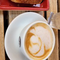 Chocolate croissant and capuccino at UNO Caffé Olistico in Bologna