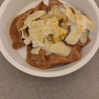 Fresh pasta with vegan parmigano at UNO Caffé Olistico in Bologna