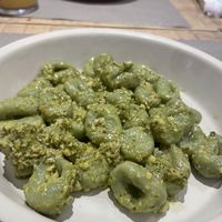 spinach gnocci with pesto  at UNO Caffé Olistico in Bologna