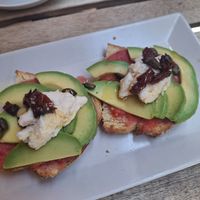 The "Tostada - Ricotta Veg, Pomodori Secchi e Avocado" at UNO Caffé Olistico in Bologna