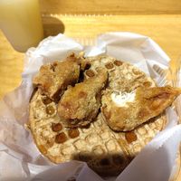 Couldn't resist taking a bite before taking this picture of chicken and waffles! at Dodah's Kitchen in Baltimore