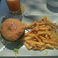 Veggie burger (vegan when ordered without cheese), fries, and fresh juice. at Surf Corner Veggie Tapas Cafe in Lanzarote